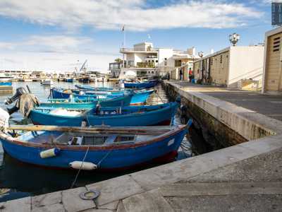 Camminiamo dunque su questa lingua di pietra, affiancando tante barchette e procedendo verso la punta del molo, l� dove un cancello in ferro d� accesso ai ripostigli riservati ai pescatori...